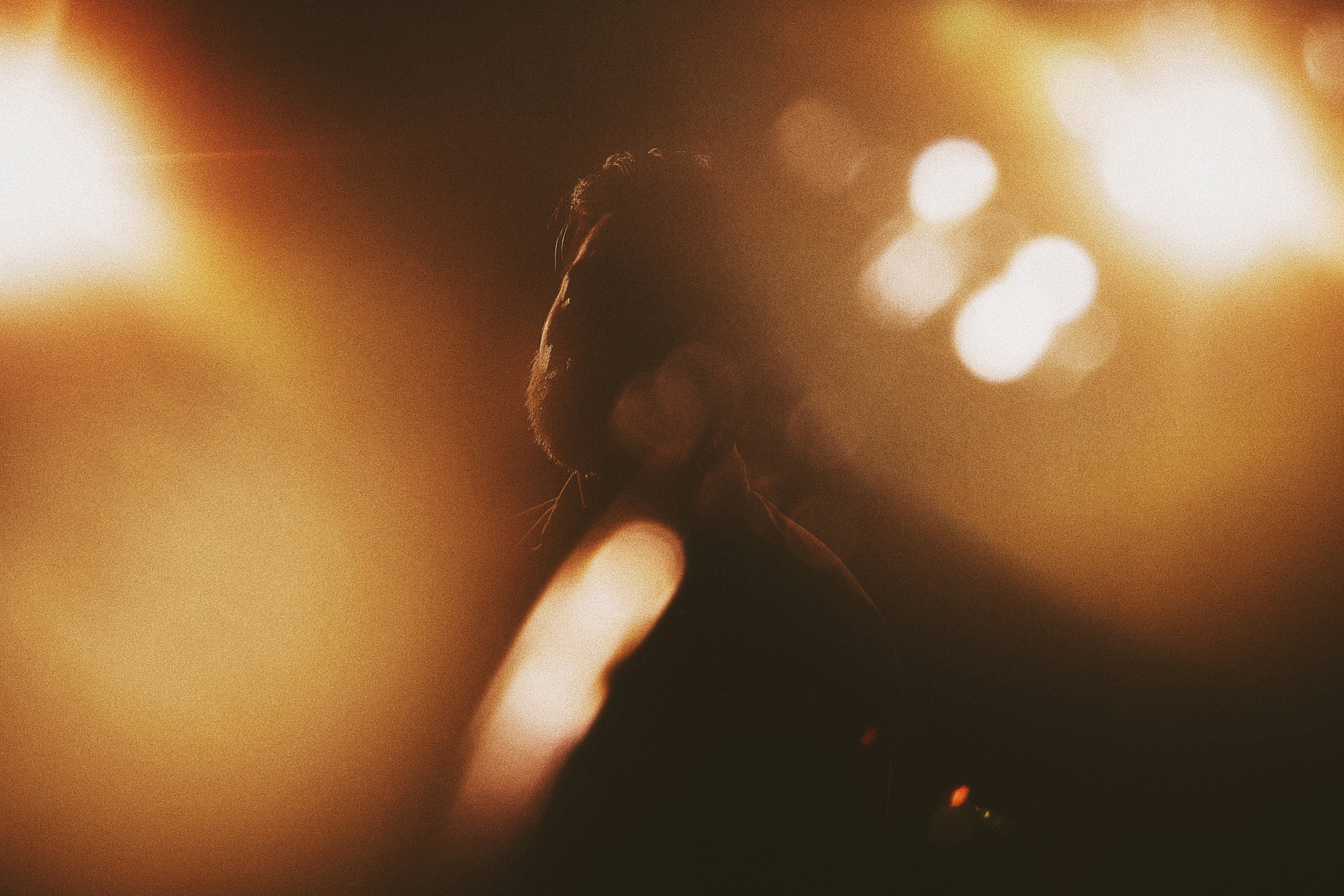 Performer on stage with dramatic amber lighting